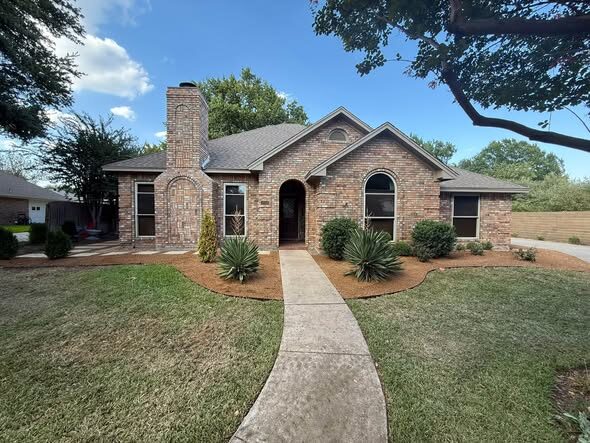 Front-yard walkway and fresh landscaping on a North Texas home