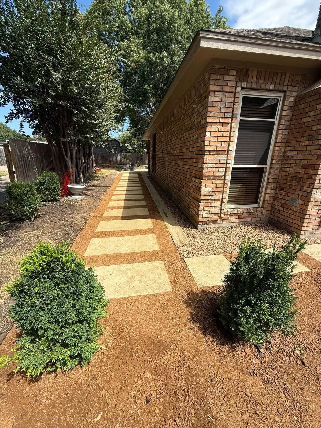 Travertine stepping-stone walkway with decomposed granite and fresh plantings