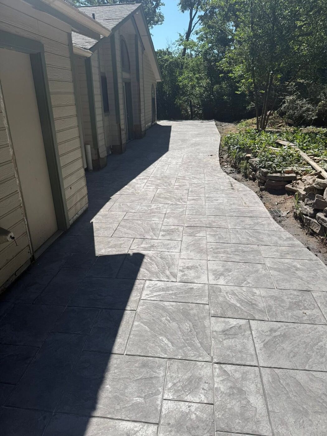 Stamped concrete walkway with a natural slate pattern by G&M in North Texas